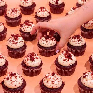 Vegan Red Velvet Cupcakes with creamy plant-based vanilla icing and red velvet crumb, freshly baked by Crumbs & Doilies.